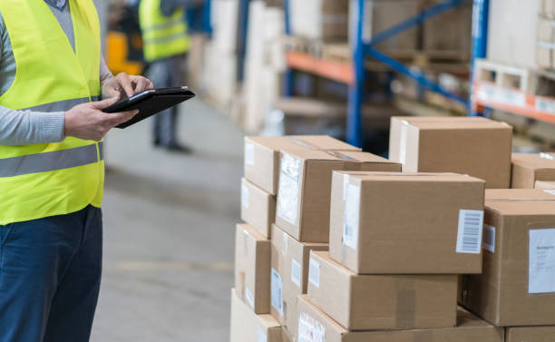 istock Male Warehouse Employee Doing Inventory Check In Warehouse 905243196