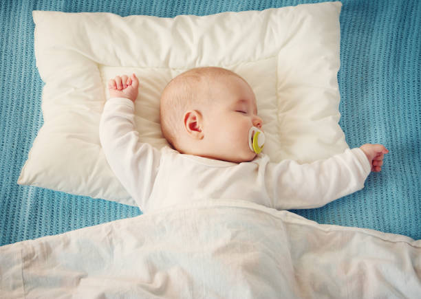 istock baby sleeping on blue blanket 905243226
