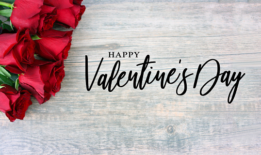 Happy Valentine's Day Text with Red Roses Over Rustic Wood Background