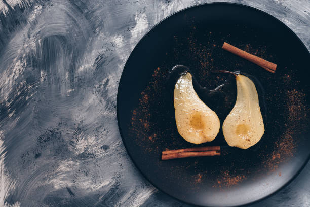 istock Pear in syrup poached served on a plate, gray background, copy space. 905247822