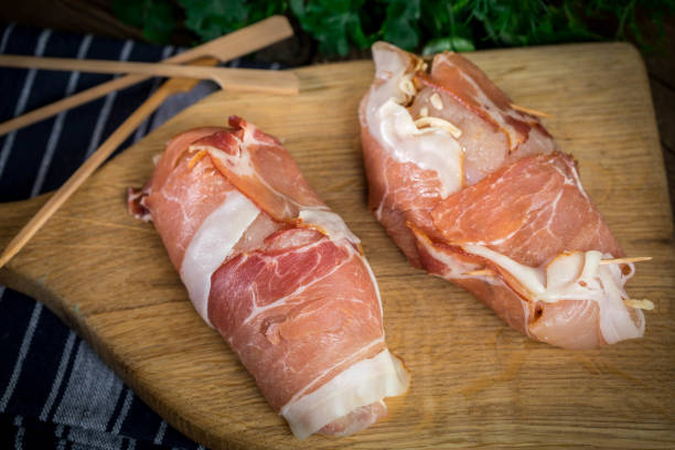 istock Raw chicken breast stuffed with champignon wrapped with bacon. 905254706