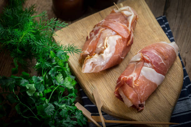 istock Raw chicken breast stuffed with champignon wrapped with bacon. 905254752