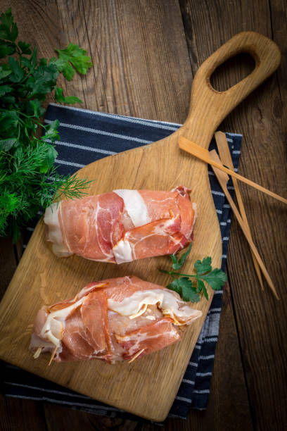 istock Raw chicken breast stuffed with champignon wrapped with bacon. 905254866