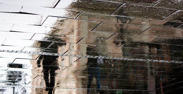 istock Rain reflection silhouette shadow of people 905262160