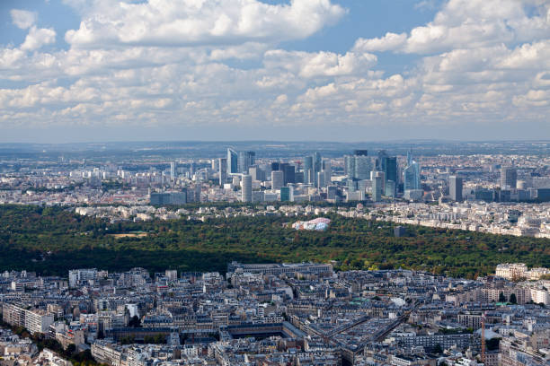 Paris, France - September 01, 2016: The Louis Vuitton Foundation next to the Jardin d'Acclimatation in the Bois de Boulogne of the 16th arrondissement of Paris, with behind, the financial district of La Défense.