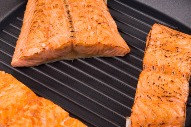 istock Grilled salmon steaks on frying pan. 905267436