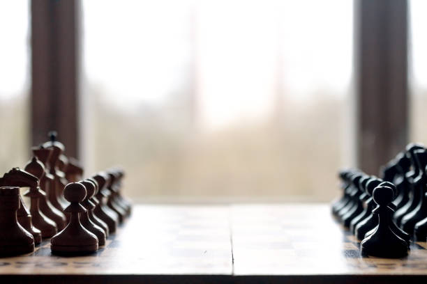 View of chess pieces lined up on a chess board stock photo