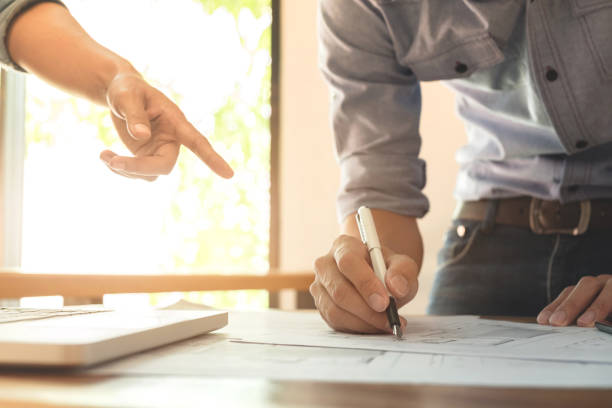 istock Image of engineer or architectural project, engineering and partner drawing plan on BluePrint with Engineering tools on workplace 905274240