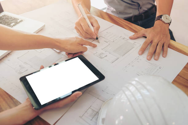 istock Image of engineer or architectural project, two engineering discussing and working on blueprint with architect equipment, Construction concept 905274348