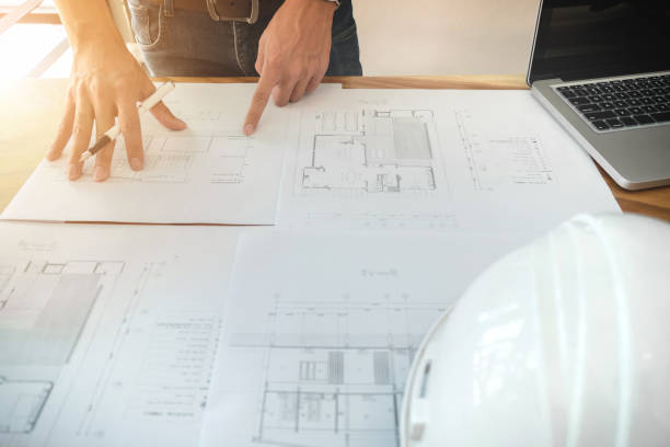 istock Image of engineer or architectural project, Close up of architects engineering working on blueprint with engineering equipment tool, construction concept 905274352