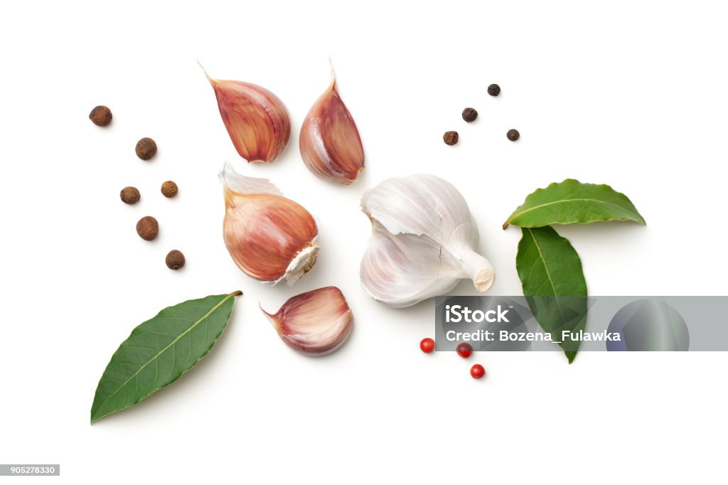 Garlic, Bay Leaves, Allspice and Pepper Isolated on White Background Garlic, bay leaves, allspice and pepper isolated on white background. Top view Garlic Stock Photo