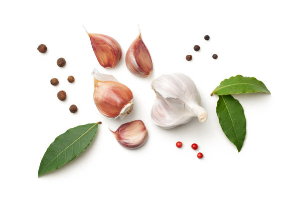 Garlic, Bay Leaves, Allspice and Pepper Isolated on White Background Garlic, bay leaves, allspice and pepper isolated on white background. Top view pepper seasoning stock pictures, royalty-free photos & images