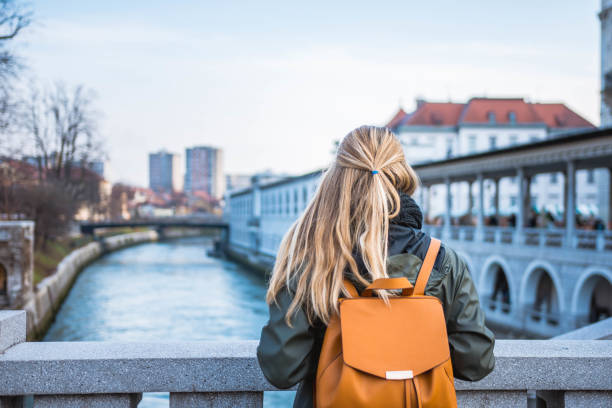 istock Woman with a backpack admiring the view 905280074