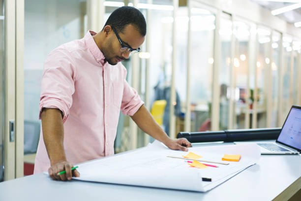istock Professional male architect brainstorming creating blueprint for new building construction using accounting application on modern laptop computer with mock up screen connected to wifi in office indoor 905280450