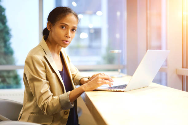 istock Attractive afro american administrative manager checking email box waiting for feedback from director of company use laptop computer and wireless internet connection. Businesswoman working on net-book 905286390