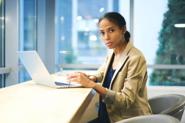 istock Concentrate afro american female skilled journalist making remote job writing press release for online issue using laptop and wifi connection in coworking office, woman executive working on net-book 905286416