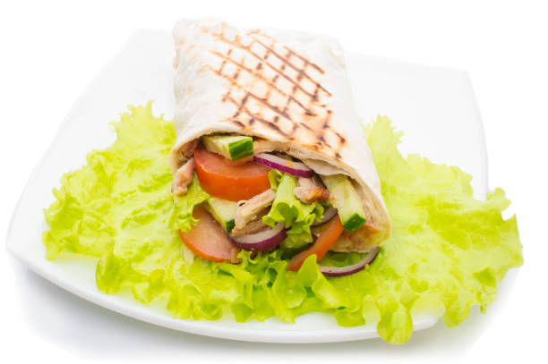 istock Shawarmas on lettuce isolated a white background 905289262