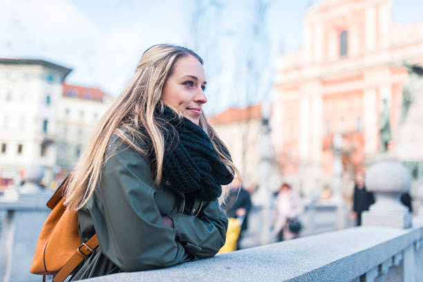 istock Woman with a backpack enjoying in the city 905289566