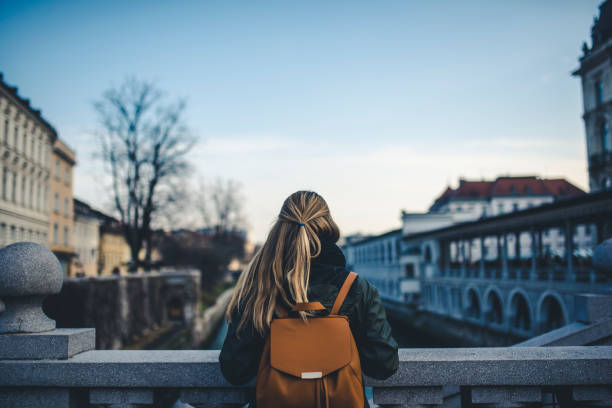 istock Woman with a backpack admiring the view 905289592