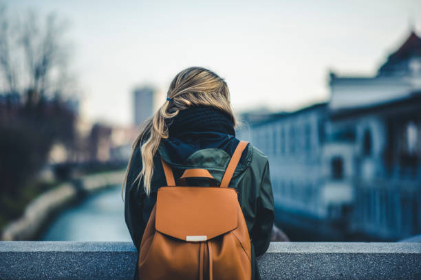istock Woman with a backpack admiring the view 905289596