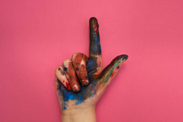 istock Baby hands in paint on a pink background. 905290166
