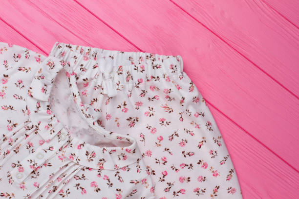istock Handmade girls clothes on pink 905299382