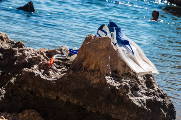 fins and a mask on the stones. Closeup or macro shoot