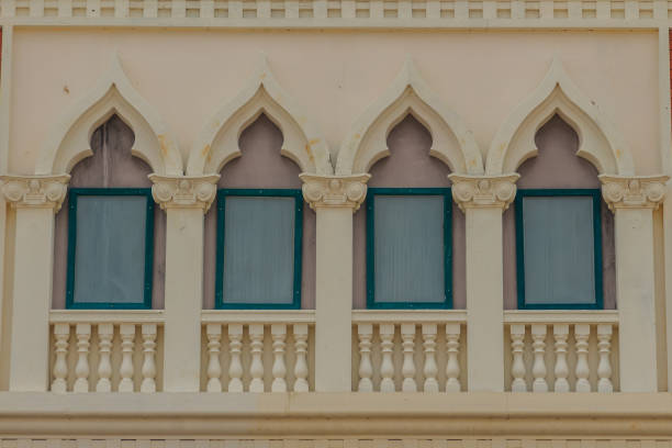 istock Row of arch windows on the balcony with stucco wall background. 905300460