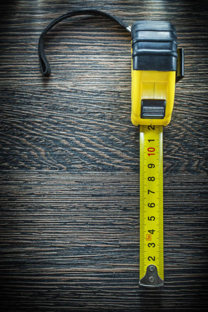 istock Tape measure on vintage wooden board 905301376