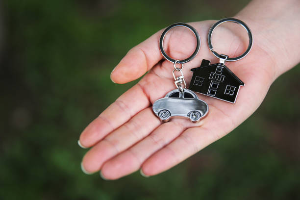 istock Women holding her car and home keys 905304428