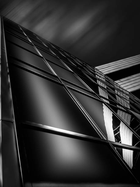 B&W close-up of glass & office building with light