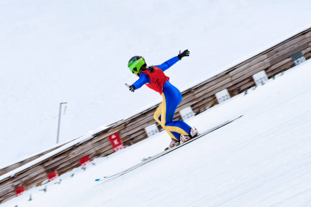 female ski jumper practicing telemark landing, - telemark skiing fotos imagens e fotografias de stock