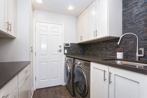istock White laundry room boasts white shaker cabinets 905319508