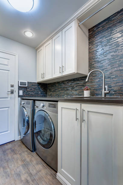 istock White laundry room boasts white shaker cabinets 905322000