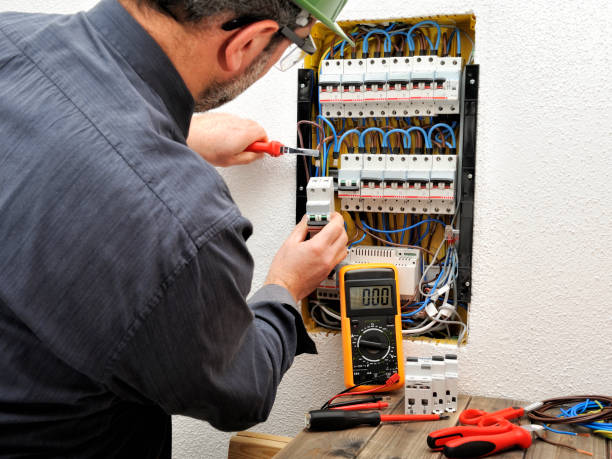 istock Electrician technician at work with protective helmet on a residential electric panel 905322330