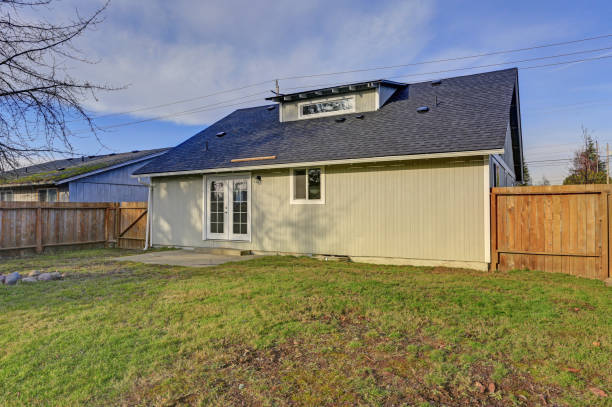 istock Spacious backyard with wooden fence and fire pit 905323034