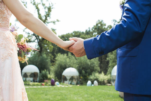 istock couple holding hands outdoors, wide angle, lower point,sunny whether 905323228