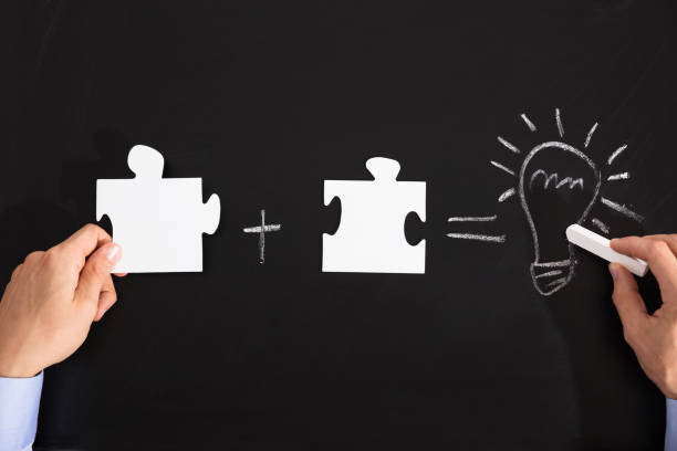 istock Person Drawing Idea Equation With White Puzzles 905323428