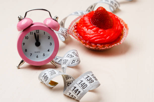 istock Sweet food measuring tape and clock on table 905325558