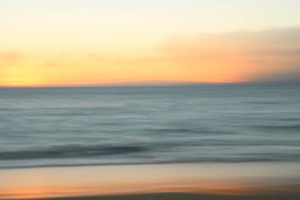 istock Abstract motion blur sunset over ocean and beach with reflection in sand 905325928