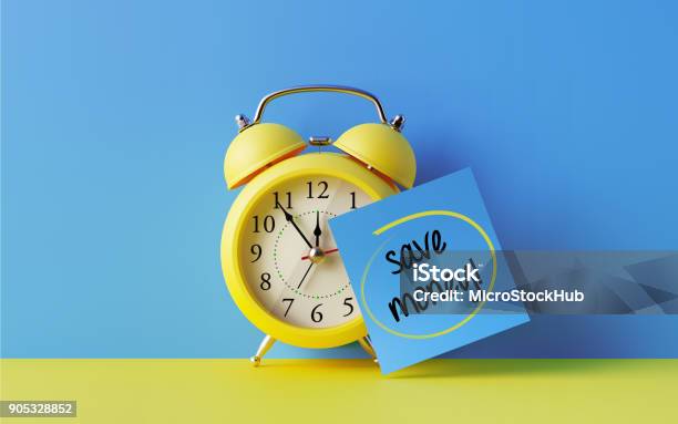 Alarm Clock And A Blue Post It Not Over Blue Background Stock Photo - Download Image Now