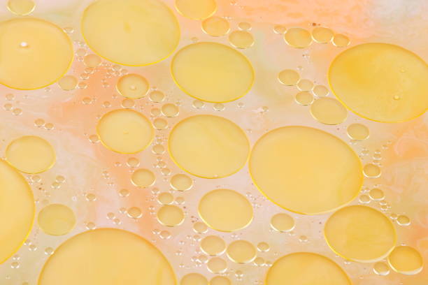 istock Drops of vegetable oil on liquid, abstract background, pop art texture, yellow circles on a light background, minimalism, pastel pattern, art 905329174