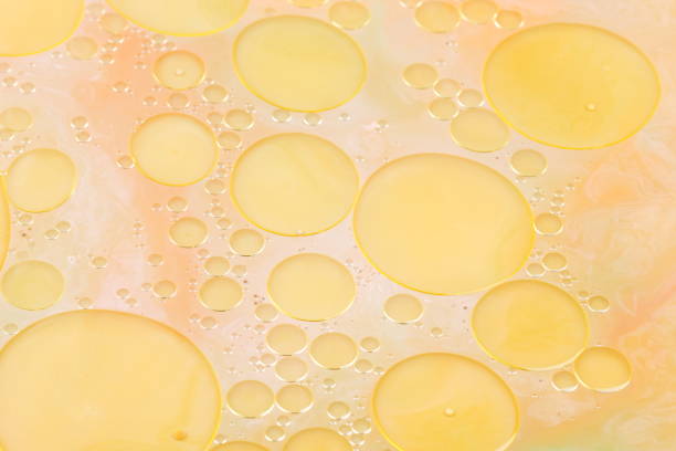 istock Drops of vegetable oil on liquid, abstract background, pop art texture, yellow circles on a light background, minimalism, pastel pattern, art 905329278