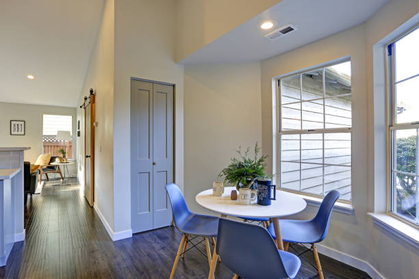 istock Lovely breakfast nook with white round table and blue chairs. 905329916