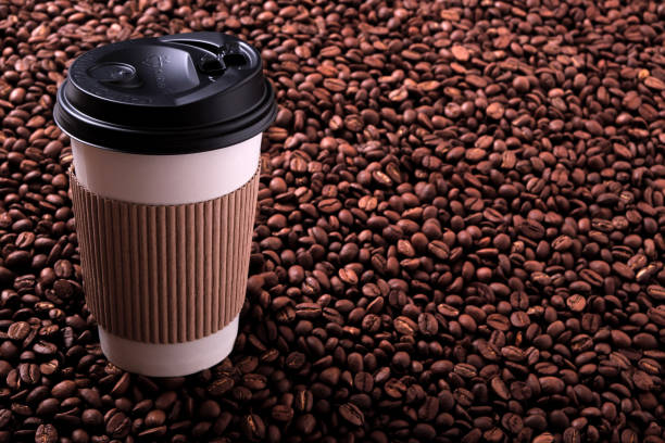 istock Takeaway coffee cup with roasted beans background 905329944
