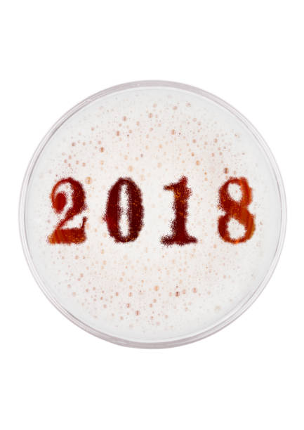 istock Glass of red ale beer top with 2018 year digits 905330082