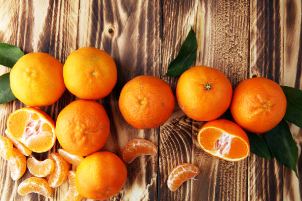 istock fresh mandarin oranges fruit with leaves on wooden table 905332784