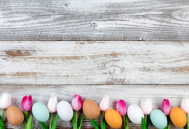 istock Natural eggs and pink tulips for Easter holiday on rustic wooden boards 905333336