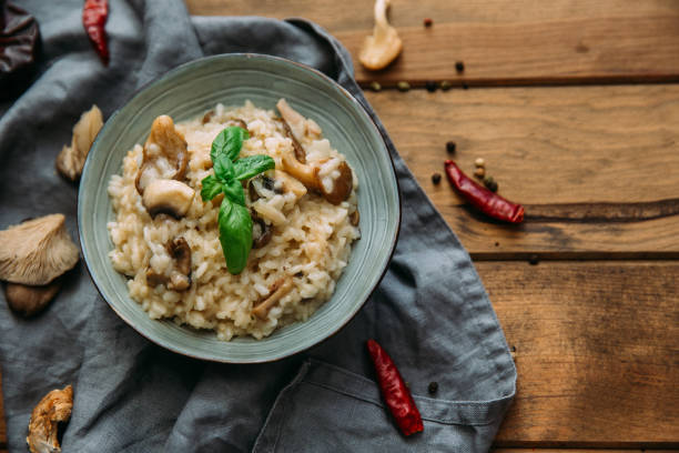 istock Risotto with mushrooms on an old wooden background. Rustic style. 905335918