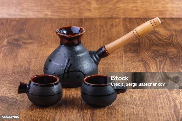 Clay Turka And Cups For Coffee On A Wooden Background Stock Photo